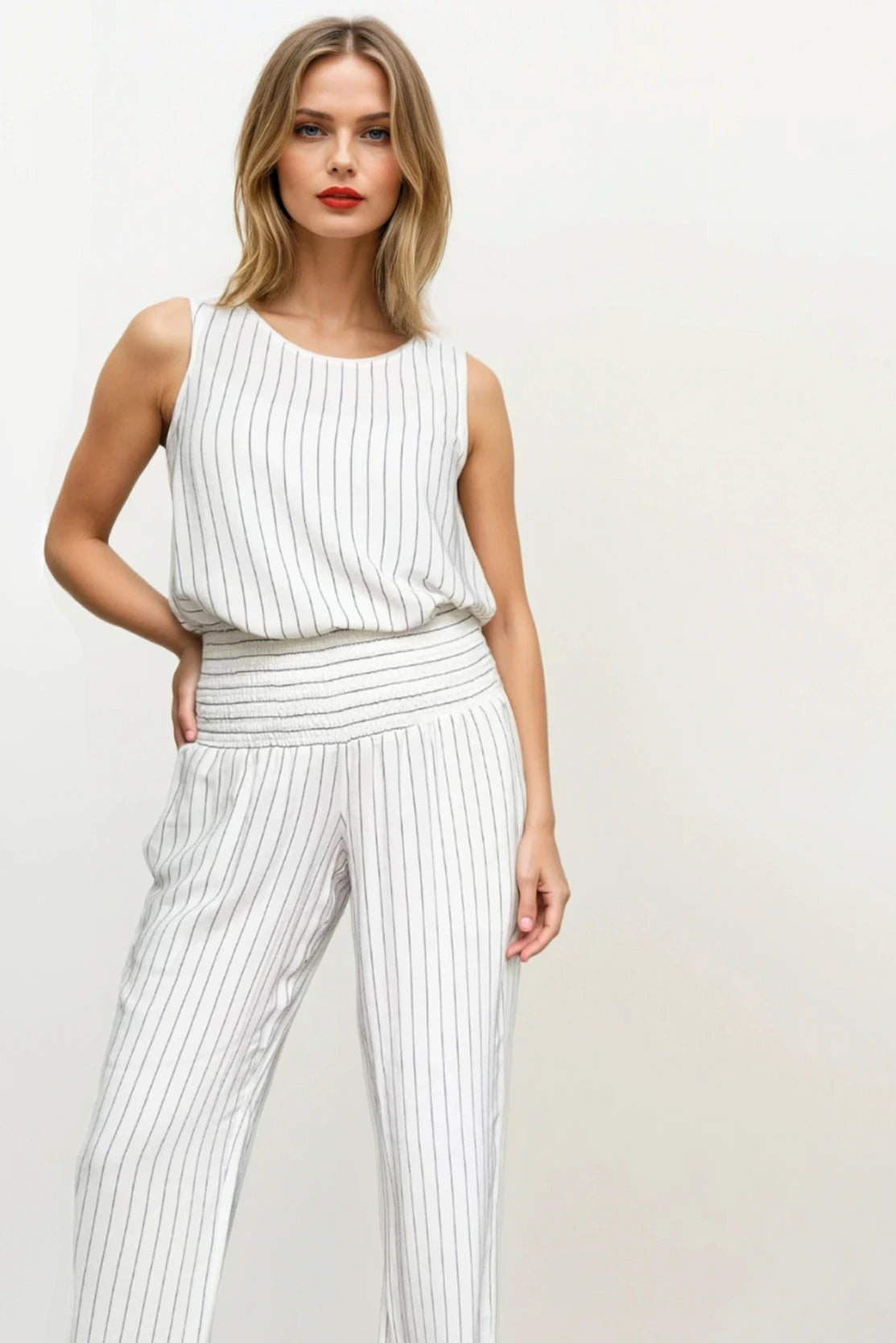 Postpartum friendly outfit, matching co ord set in ivory with black pinstripes by designer womenswear brand relaxed waist trousers & top for smart events