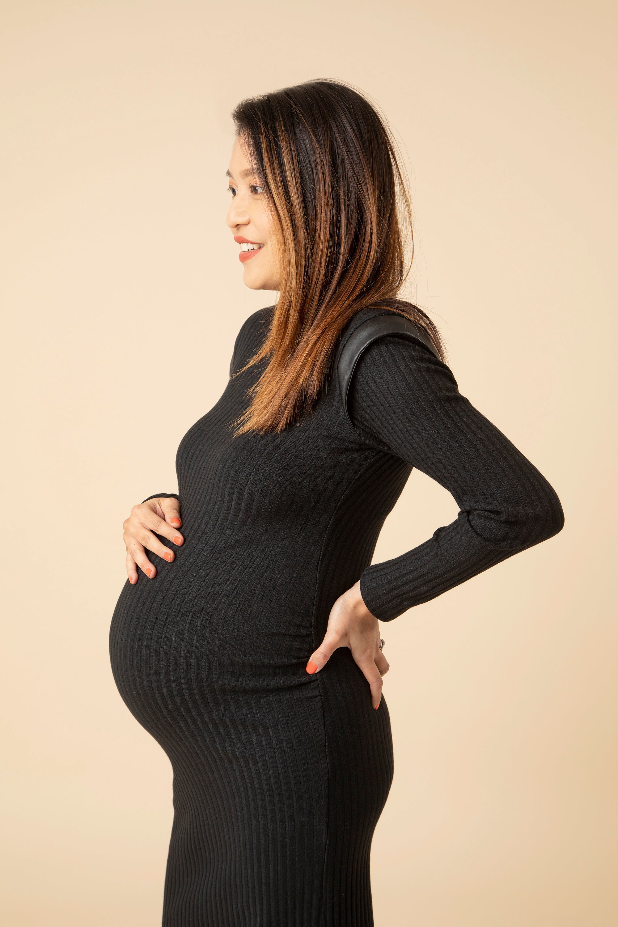 This maternity dress is a must-have 'Little Black Dress' for every stylish maternity wardrobe. Made in skin-soft fabric that hugs your growing curves in all the right places. Discreet ruching gives the ‘perfect fit’ bump silhouette. The ideal modern maternity office wear dress that will take you from day to evening.