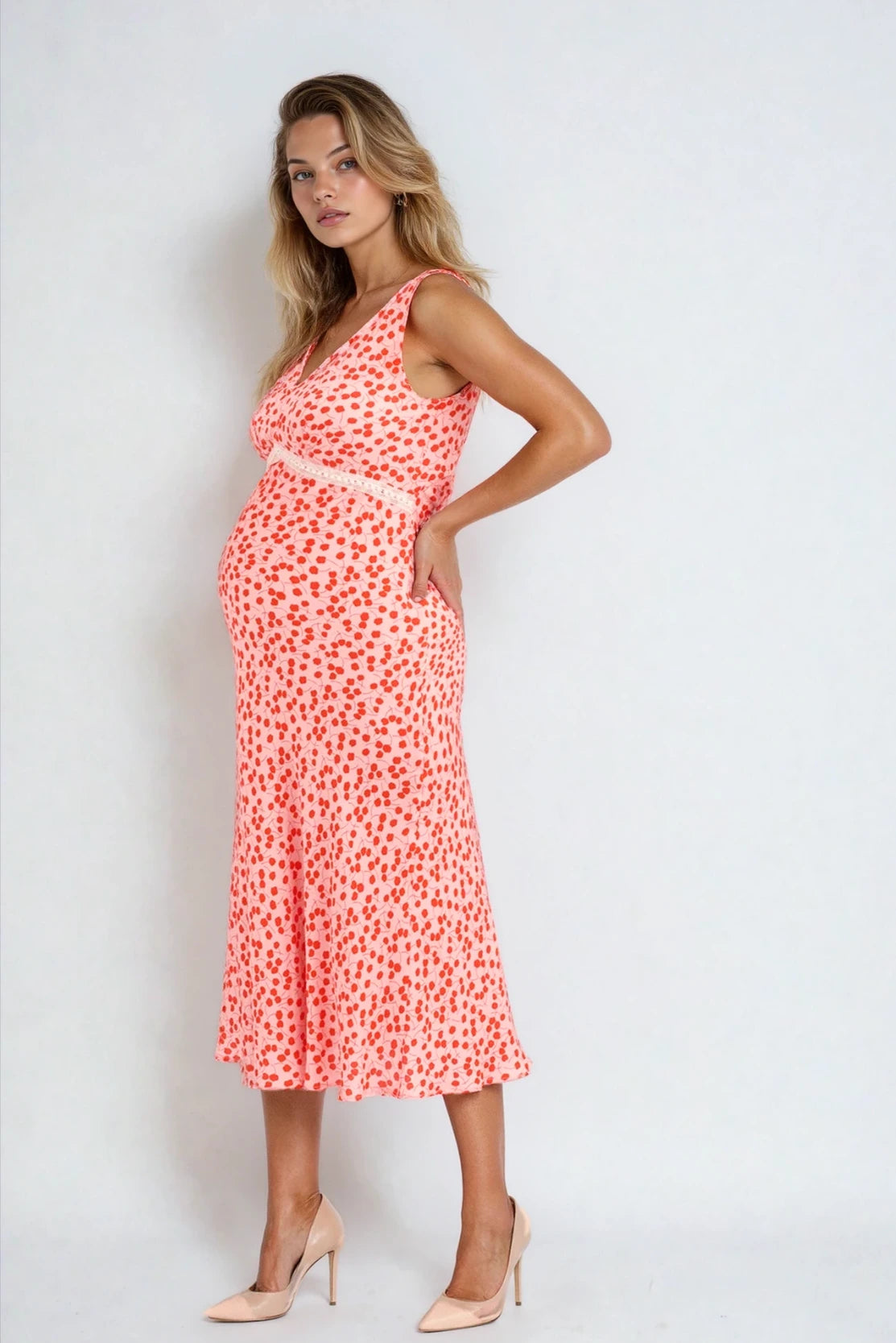 pregnant woman in an elegant sophisticated high end premium quality maternity occasion dress - Rixo dress that works for pregnancy